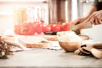 preparation of dishes on a wooden kitchen table in the light of the Tuscan sun