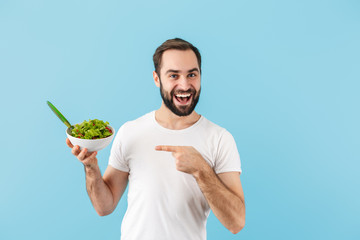 Handsome young bearded man wearing t-shirt standing