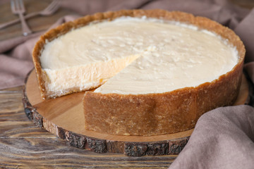 Sweet tasty cheesecake on table