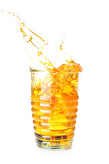 Glass of cold cocktail with splashes on white background