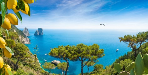 Panoramic image with famous Faraglioni Rocks, most visited travel attraction near Capri Island,...