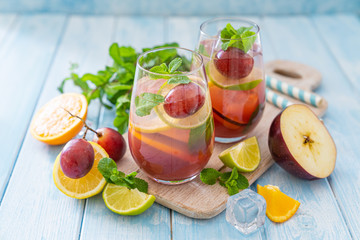 Sangria and ingredients on blue wood background, summer, copy space