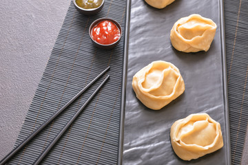 Plate with oriental dumplings on table