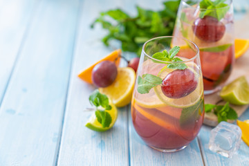 Sangria and ingredients on blue wood background, summer, copy space
