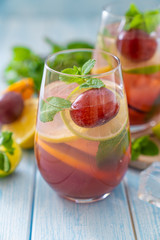 Sangria and ingredients on blue wood background, summer, copy space