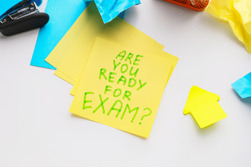 Paper sheets with text ARE YOU READY FOR EXAMS? on white background