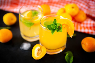 cups apricot lemonade with mint, fresh apricots, orange towel