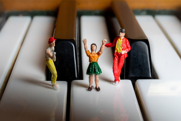 Miniature People having a party on a piano