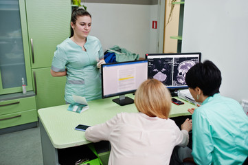 Medical theme. Observation room with a computer tomograph. Doctor advises the patient in the mri...
