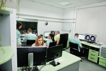 Medical theme.Observation room with a computer tomograph. The group of doctors meeting in the mri...