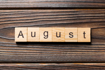 August word written on wood block. August text on wooden table for your desing, Top view concept