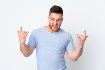 Fototapeta premium Russian handsome man over isolated background making horn gesture
