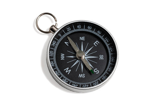 Compass with a black dial isolate on a white background. Traditional navigation device indicating the cardinal points (north, south, east, and west).
