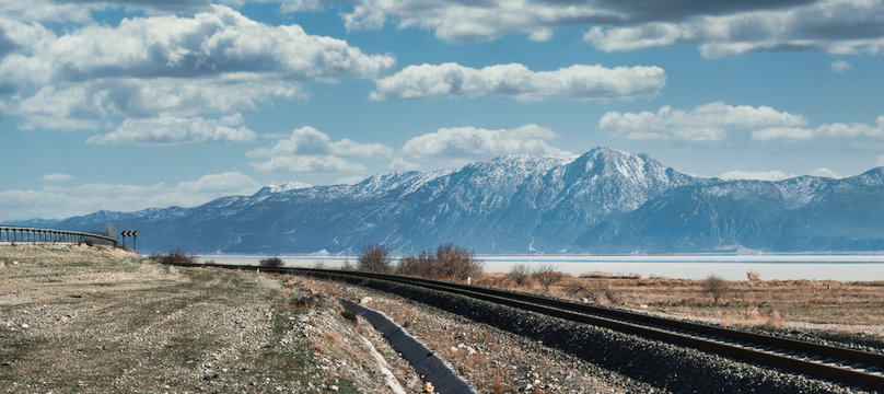 Railroad Lake Snowy Mountains Cloudy Sky