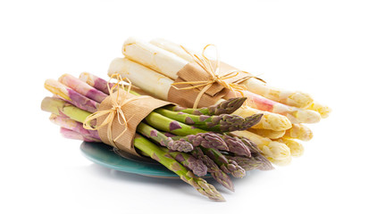 Green and white asparagus on a green plate, isolated on white