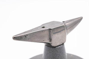 Small anvil in front of white background