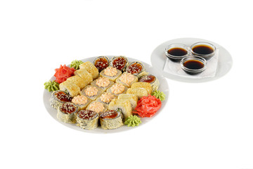 Set of sushi for a large company, rolls, california, philadelphia with lava sauce, marinated ginger, soy sauce and wasabi, white isolated background, side view