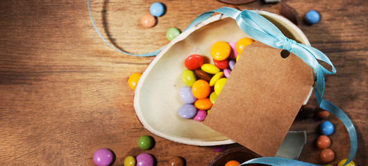 Colorful Easter candies on a rustic wood background