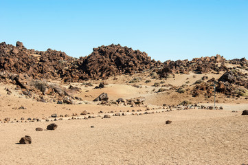 Fototapeta na wymiar Landscape of the ancient Caldera of the Teide volcano. Trekking path leading to the desert.