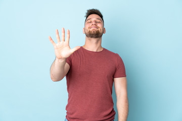 Russian handsome man over isolated background counting five with fingers