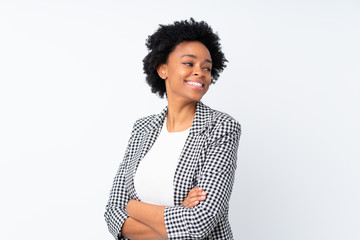 African american woman with blazer over isolated white background with arms crossed and happy