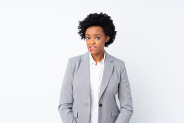 African american business woman over isolated white background having doubts and with confuse face...
