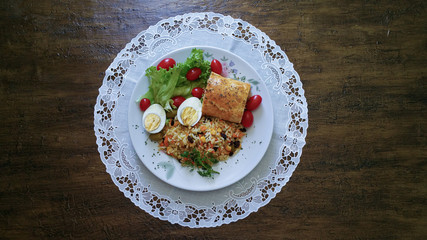 Fototapeta na wymiar Lunch food dish. Salad, egg, tomatoes, greek rice and breaded