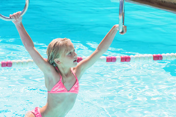Child on water slide at aquapark. Summer holiday.