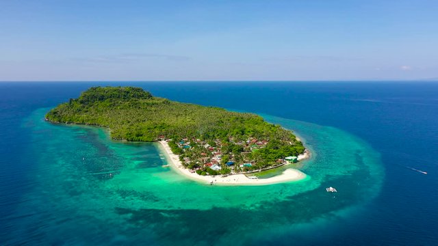 Himokilan Island, Leyte Island, Philippines. Tropical island with a village and a white beach. Tropical island with a white sandy beach, top view.