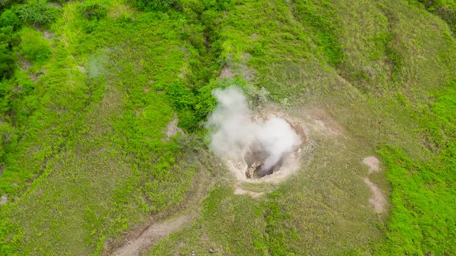 The crater of Taal volcano with Smoking fumarole, foreshadows the eruption of the volcano, aerial view. Tagaytay, Philippines.