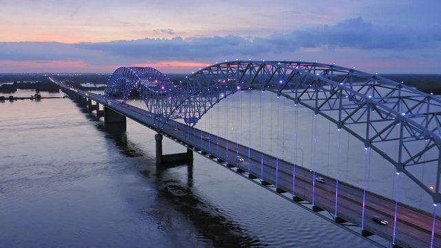 Aerial flying over traffic on the Hernando de Soto Bridge that crosses the Mississippi River at night. The bridge crosses into Arkansas. Memphis, Tennessee, USA