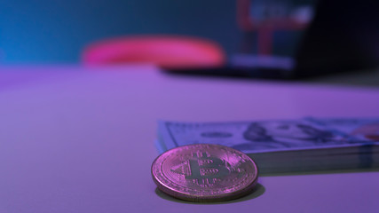 Bitcoin coins and dollars on the table