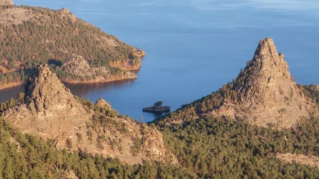 Majestic nature of Kazakhstan concept: epic view of Burabay lake with Okzhetpes and Zhumbaktas rocks from the highest point of Sinyuha Mountain at sunset in autumn season; time lapse zoom in