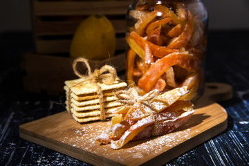Homemade candied peels orange confiture in glass jar with spices