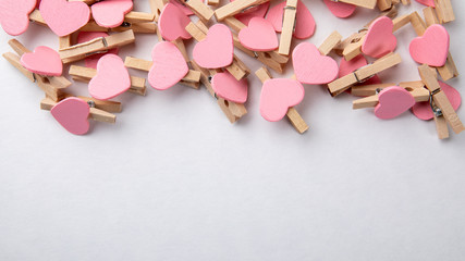 Wooden clips with Pink heart. White background with copy space