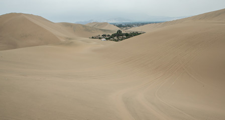 Fototapeta na wymiar Oasis. Huacachina Peru. Desert. Dunes. 