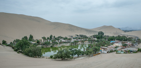 Oasis. Huacachina Peru. Desert. Pond and palmtrees