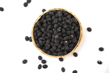 Fototapeta na wymiar A pile of black beans in the bamboo basket