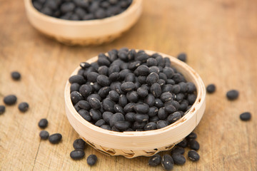 A pile of black beans in the bamboo basket