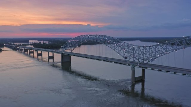 Aerial flying over traffic on the Hernando de Soto Bridge that crosses the Mississippi River at night. The bridge crosses into Arkansas. Memphis, Tennessee, USA