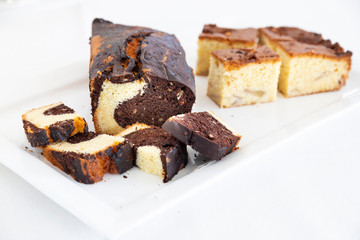 Homemade rustic style chocolate plumcake. Typical lifestyle image. White background.