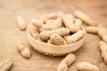 A pile of peanuts in a bamboo basket