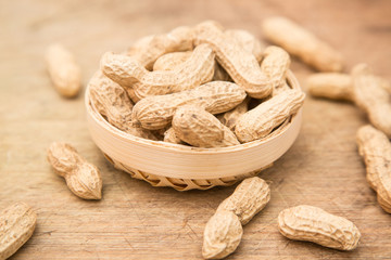 A pile of peanuts in a bamboo basket