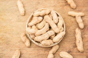 A pile of peanuts in a bamboo basket