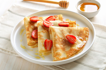 Crepes with strawberry slices
