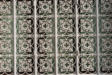 Closeup of a window with an old decorative metal grate, Bologna downtown, Emilia-Romagna, Italy, Europe