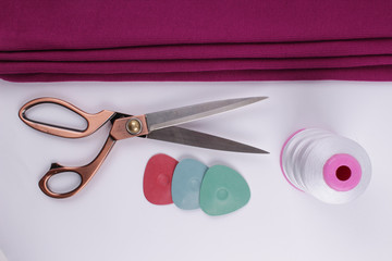 scissors, ruler, thread on a fabric