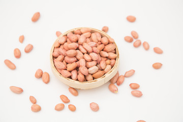 A pile of peanuts in a bamboo basket