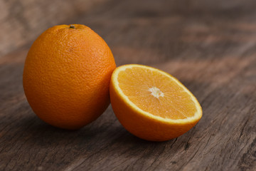 Orange Healthy fruits, half of orange  with oranges on the wooden table background. Soft selected focus. Copy space