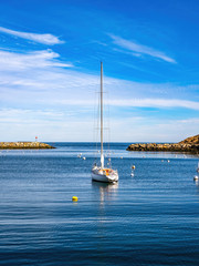sailboat anchored in water in bay